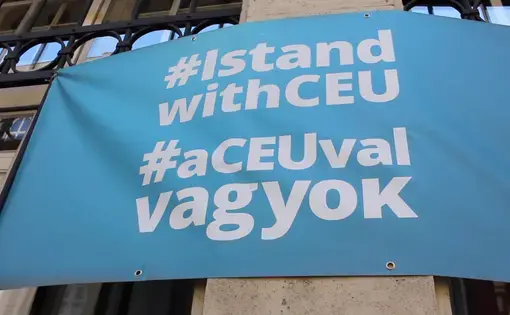 A banner reads "Hashtag: I Stand With CEU," referencing many students' wish to stay in Budapest.