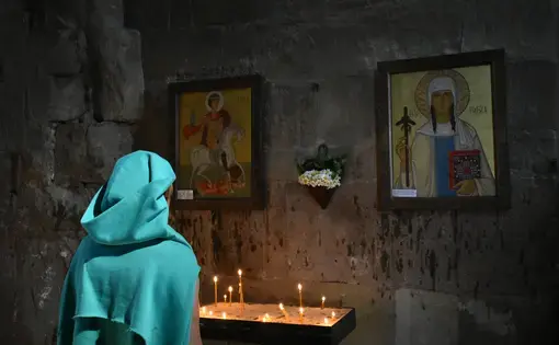 An Orthodox woman prays at the Jvari Monastery. Image by Kaitlyn Johnson. Georgia, 2019.
