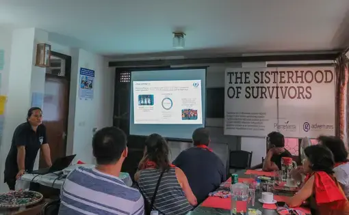 Indira Gurung, co-founder of NGO Samrakshak Samuha Nepal, discusses human trafficking in Nepal to a group of travelers. Image by Nicole Brigstock. Nepal, 2018.