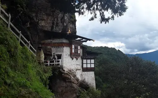 A Buddhist temple hangs off a cliff in the Tang Valley in Bumthang, a district in central Bhutan. Image by Emma Johnson. Bhutan, 2019.