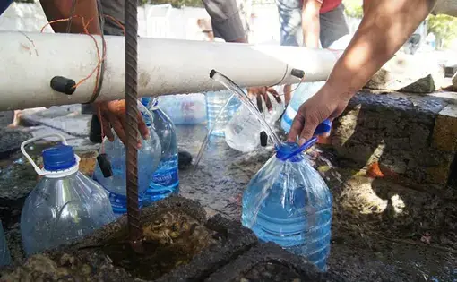 Cape Town residents fill their water jugs at the Highlands Spring. Image by Jacqueline Flynn. South Africa, 2018.