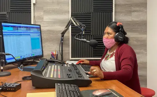 Lidia López prepares to go on-air from Radio Indígena's programming booth in Oxnard in July. Image by&nbsp;Julia Knoerr. United States, 2020.