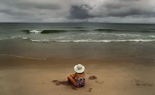 Salome Verkoville, 10 from Boston sits on Nauset Beach. Image by John Tlumacki. United States, 2019.
