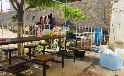 The patio outside a shelter in Ciudad Juárez. Migrants from Central America and Cuba gather here to socialize and wash their clothes at the outdoor spigot. Image by Lily Moore-Eissenberg. Mexico, 2019.
