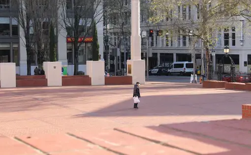 April 7, 2020 – A lone man walks across Pioneer Courthouse Square in downtown Portland. Image by Sarah Fahmy. United States, 2020.