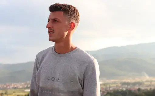 Albin Heta, 19, the cousin of Blerim Heta, poses in his small village called Varosh. Blerim left to fight for jihad in Syria on August 7, 2013. On March 25, 2017, Blreim became one of two Kosovo-Albanian suicide bombers, killing himself and 52 Iraqis in a bombing in Baghdad. “He was polite and nice, but in three months, he changed completely,” said Albin. Image by AJ Naddaff. Kosovo, 2018.