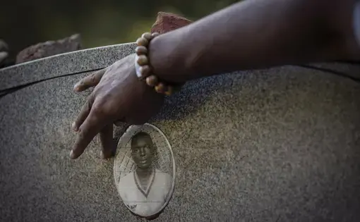 A portrait of James Chaney is seen on the headstone of his grave in Meridian, Miss., Saturday, Oct. 3, 2020. Chaney was one of three civil rights activists that was kidnapped by a deputy sheriff and local Klansmen, and driven to a narrow country road and shot at close range. Their bodies, buried in an earthen dam, were found 44 days later. Image by Wong Maye-E / The Associated Press. United States, 2020.