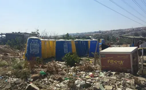 Trash piled up around Setswetla's chemical toilets. Image by Christian Belanger, South Africa, 2016.