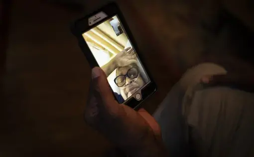 Mike Bishop video chats in Byram, Miss., with his wife, Bonnie Bishop, who is hospitalized 40 miles away, on Thursday, Oct. 8, 2020. He's hoping she'll be back by Thanksgiving. Image by Wong Maye-E/AP Photo. United States, 2020.