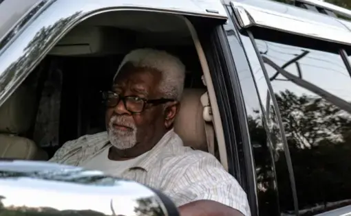 Pepper Holder sit in his SUV in front of one of the entrances to the old Koppers Tie Plant in Carbondale, Illinois on August 24, 2020. Image by Amelia Blakely. United States, 2020.