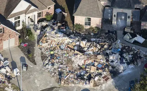 Hurricane Harvey is expected to be the costliest natural disaster in U.S. history. Thousands of homes were flooded, many requiring major repairs. Here debris piles await removal from gutting two homes in Northwest Forest, a subdivisions of Beaumont. Image by Dan Grossman. United States, 2017.&nbsp;