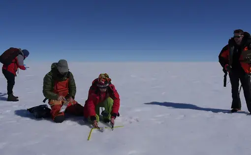 Scientists take measurements on the surface of the Greenland ice sheet. Image by Eli Kintisch. Greenland, 2016.