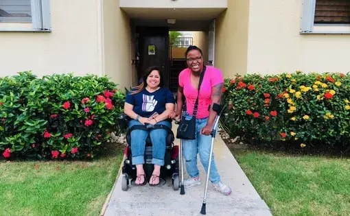 Keishla Rolón (left) and Alexis Smith in front of Keishla's home in Puerto Rico. Image by Kyja Reeves. United States, 2018.