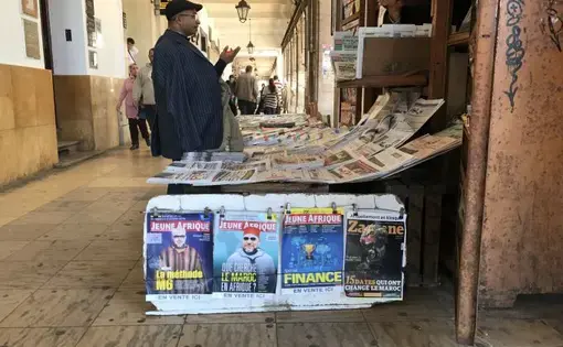 A customer talks to the vendor of a newsstand in Morocco’s capital. Very few publications in Morocco offer critical reporting of the government or the royal family, which uses a system of economic oppression to control what is published. Image by Jackie Spinner. Morocco, 2017.