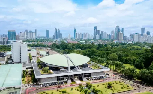 Aerial Image of the Indonesia Parliament Complex, also known as the DPR / MPR building, with Jakarta's cityscape at midday. Image by  Creativa Images / Shutterstock. Indonesia, 2018.