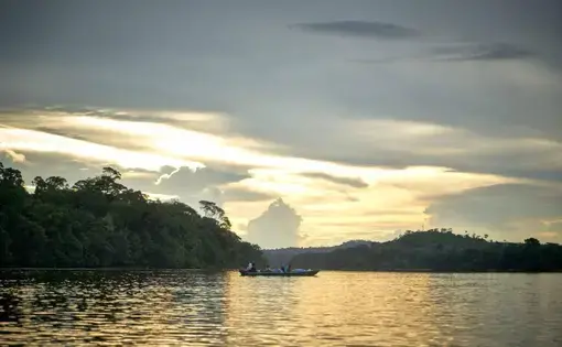 A boat sails over the Arinos River. Image by Pablo Albarenga. Brazil, 2018.