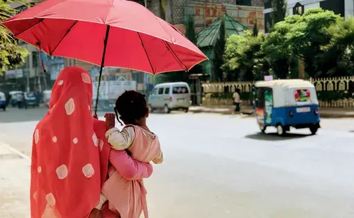 Zebiba Hassan-Ali holding her daughter, Mita, while walking in the center of Dessie. Image by Arianne Lachapelle Henry. Ethiopia, 2019.