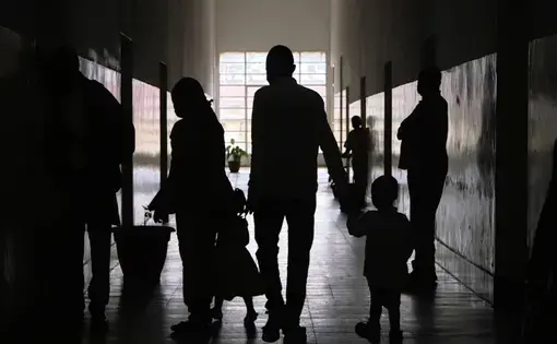 Silhouette of a family walking in a building.