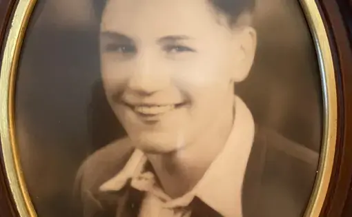 A black-and-white photo, in a frame, of a young man.
