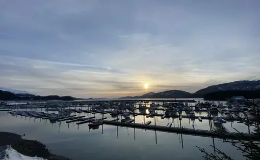 A harbor with mountains in background.