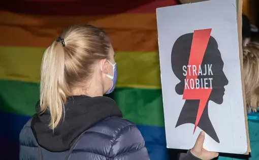 A demonstrator holds a sign reading "Women's Strike" in Polish during an abortion rights protest.
