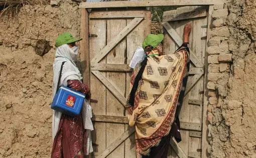 A female polio worker marks a house as visited after vaccinating children at a Christian colony in Lahore, Pakistan.