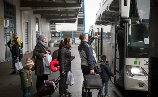Syrian refugees at Hanover airport boarding a bus to Friedland, Germany.