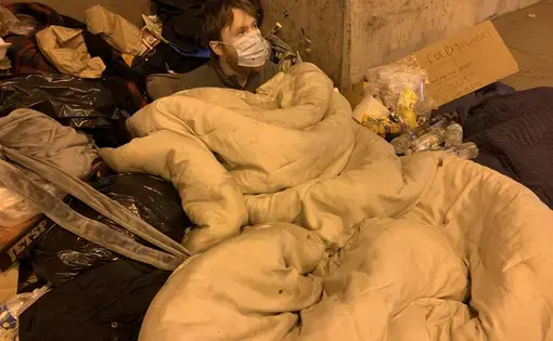 Michael in sleeping bag outside