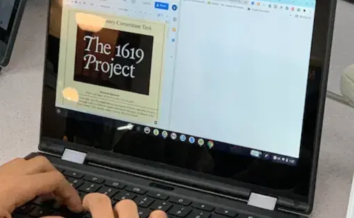 Classroom Photo. Student typing on computer. 1619 Project on computer screen.