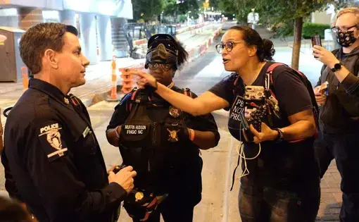a woman talks to police officer