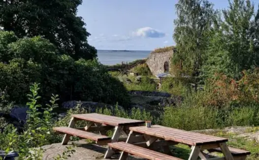 an idyllic natural scene with picnic tables at one of Finland's open prisons