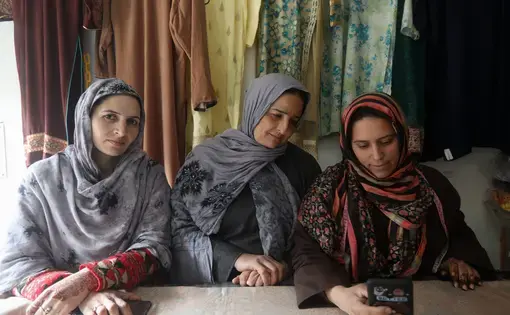three women sit at a table