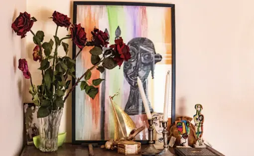 roses and artwork on table