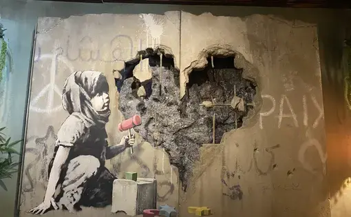 A child plays with blocks in Banksy’s Walled Off Hotel. Bethlehem, Palestine.