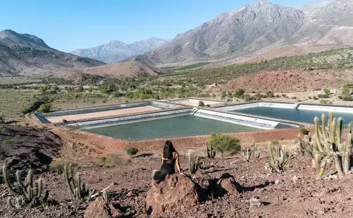A person looks out on a reservoir