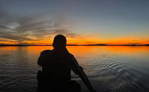 man on boot in sunset