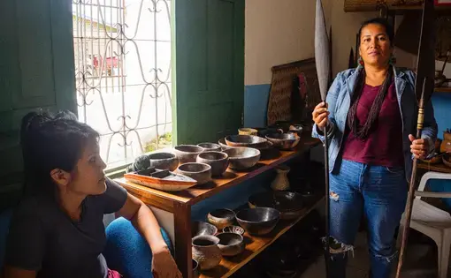 two people holding traditional tools