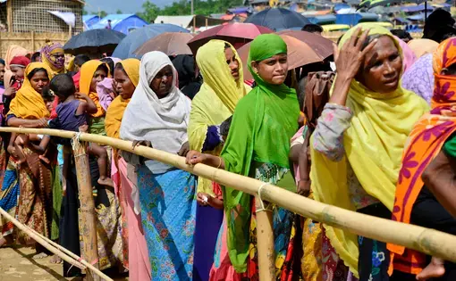 Rohingya refugee women wait to collect relief aid at the palongkhali makeshift Camp in Cox's Bazar, Bangladesh, on October 06, 2017. Image by Mamunur Rashid/Shutterstock.