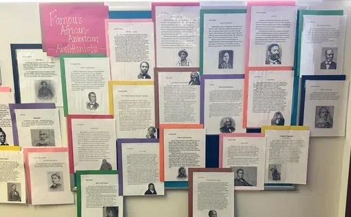 A bulletin board with multi-colored student-made posters about Black Abolitionists.
