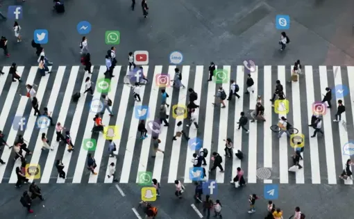 Image of people walking on a crosswalk with social media icons above their heads, screenshot from "Decoding Deception: The Psychology of Combating Misinformation" video
