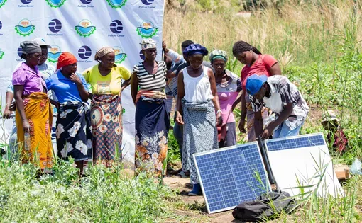 people at an event with solar panels