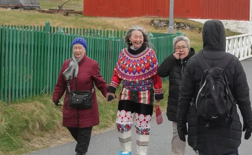 People wearing the Greenlandic national costume complete with Kamik boots, soft boots made from seal skin.