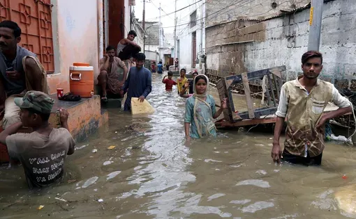KARACHI, PAKISTAN - AUG 22: Residents are facing difficulties due to flooded area caused by heavy downpour of monsoon season due to poor sewerage system, on August 22, 2020 in Karachi.