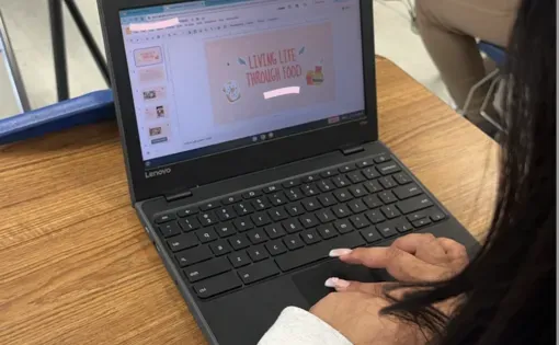 A student creates a photo slideshow about the importance of food in her community