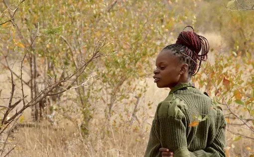 Black Mamba ranger Naledi Malungane scans the bush in the Balule Nature Reserve of Kruger National Park on the lookout for snares set by poachers. Photo by Olivia Lockett. South Africa, 2025.