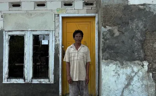 Man stands in front of door