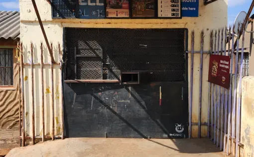 Closed foreign-owned ‘tuck shop’ or spaza shop in Naledi, Soweto, Johannesburg, South Africa, after allegations of illegal pesticides in a snack that killed six children in October of 2024. Image by Naomi Campbell. South Africa, 2025.