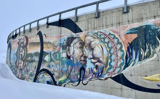 A mural at Qikiqtani General Hospital, created by Iqaluit artist Jonathan Cruz alongside community members, celebrates Inuit culture and the creativity that continues to shape cultural healing and connection. Image by Caroline Dignard.