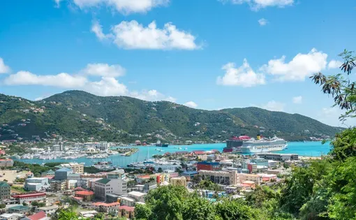 aerial view of a harbor in the british virgin islands. Clear skies, turquoise waters, homes and a cruise ship