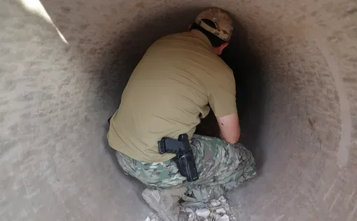 Hobayd, a senior commander of the Uyghur militants in Syria, crouches in a strategic tunnel used during the 2024 offensive against then-President Bashar al-Assad's regime.